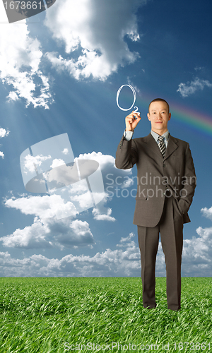 Image of asian businessman writting something outdoors