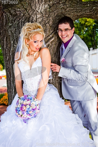 Image of Groom and bride in a sunny summer park