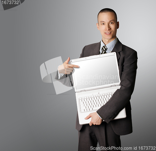 Image of businessman with open laptop shows something