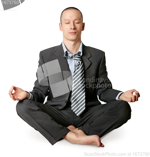 Image of businessman in lotus pose meditating