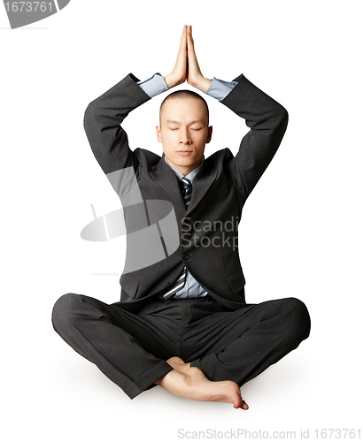 Image of businessman in lotus pose meditating