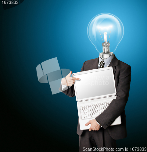 Image of businessman with lamp-head with open laptop shows something