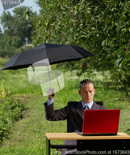 Image of businessman with umbrella