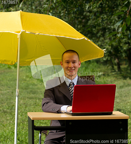 Image of businessman with umbrella