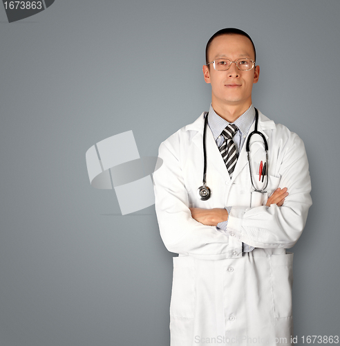 Image of doctor in glasses smiles at camera
