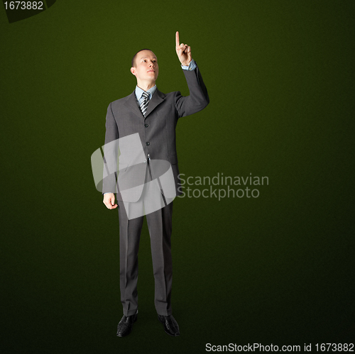 Image of full length businessman push the button