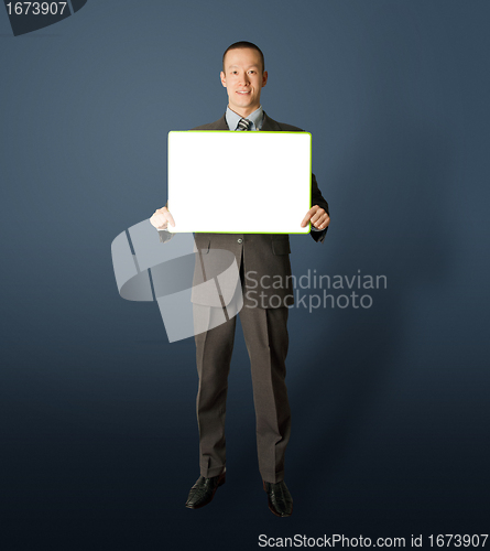 Image of happy businessman holding blank white card