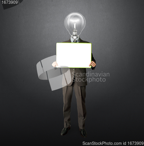 Image of happy businessman with lamp-head holding card