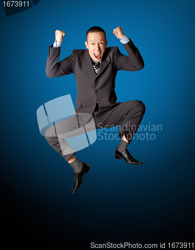 Image of Happy businessman jumping