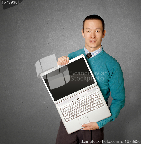 Image of Male in blue with laptop