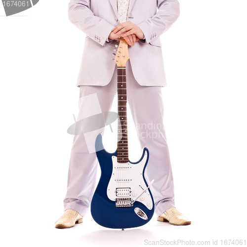 Image of man standing with electro guitar