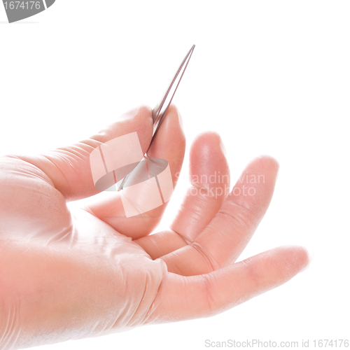 Image of hand in rubber glove holding tweezers