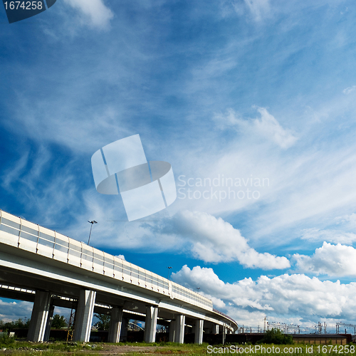Image of urban landscape with highway and clouds