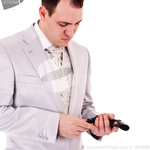 Image of man in white suit reload the gun