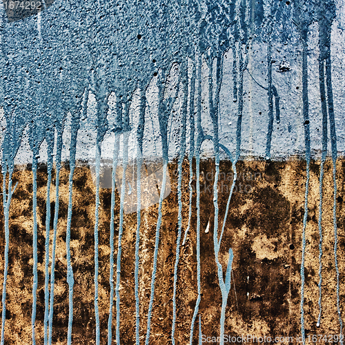 Image of concrete wall with drips of blue paint