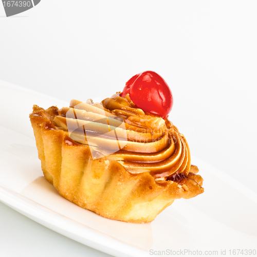 Image of cake with cherry on dish