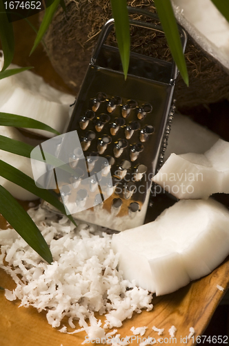 Image of Grated coconut with grater and nut 