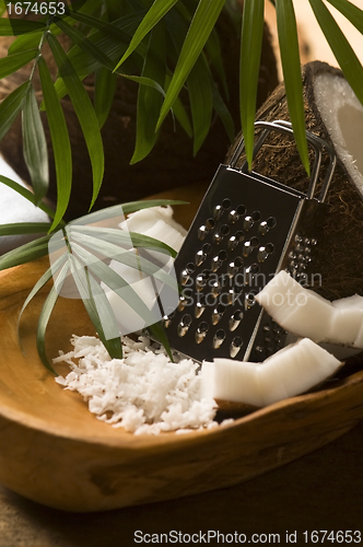 Image of Grated coconut with grater and nut 