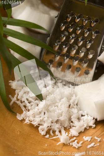 Image of Grated coconut with grater and nut 