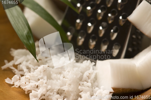 Image of Grated coconut with grater and nut 