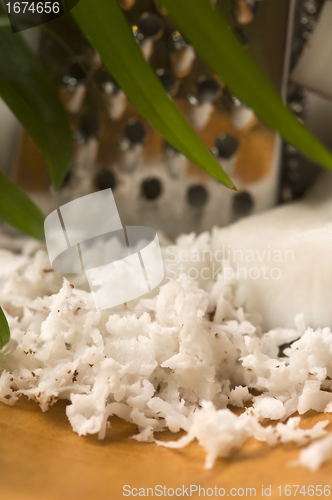 Image of Grated coconut with grater and nut 