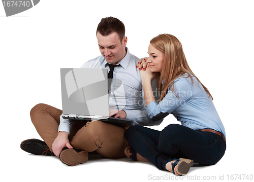 Image of Young couple working on a laptop