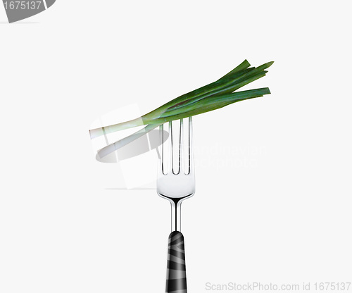 Image of green onion pierced by fork,  isolated on white background 