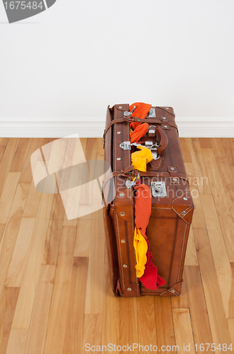 Image of Leather suitcase with too much clothing