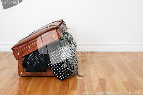 Image of Polka dot clothing in a retro suitcase