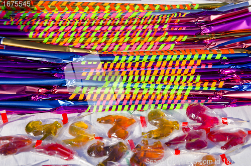 Image of Long and delicious candies with colorful papers 