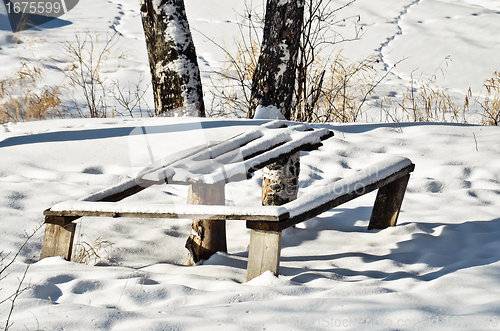 Image of Table and bench in winter forest