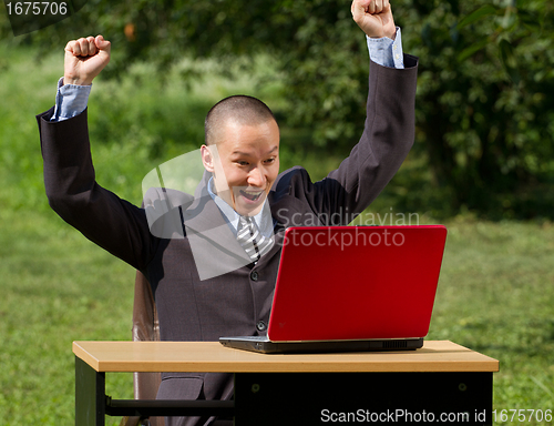 Image of man with laptop working outdoors