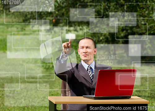 Image of man with laptop working outdoors