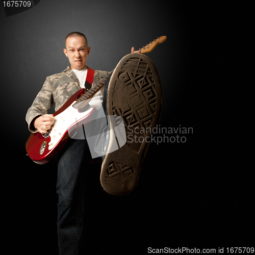 Image of rocker with guitar and foot