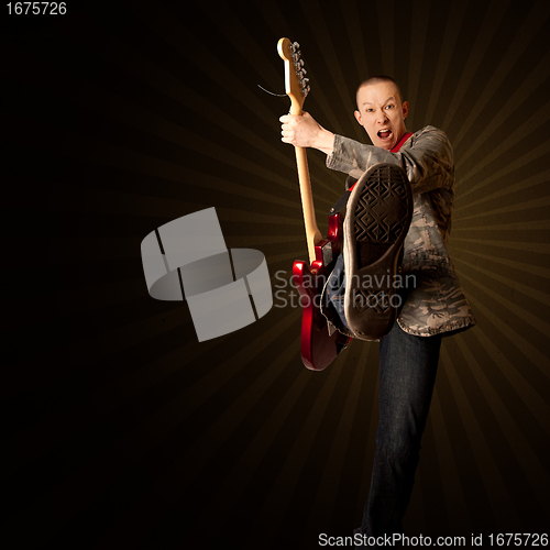 Image of rocker with guitar and foot