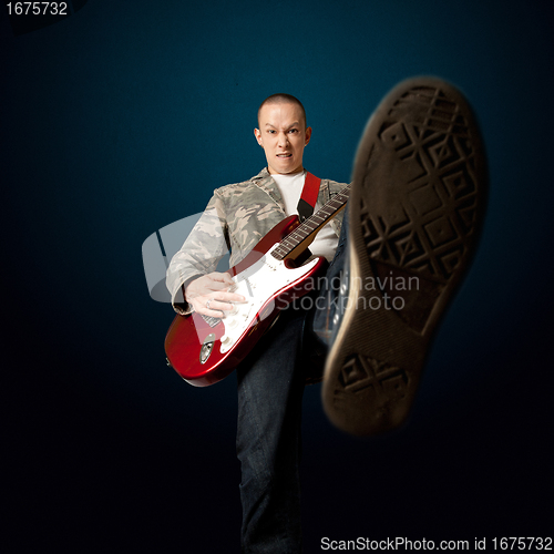 Image of rocker with guitar and foot