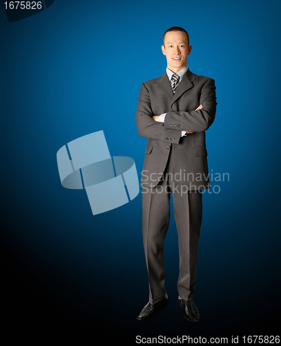 Image of smiling standing businessman in suit 