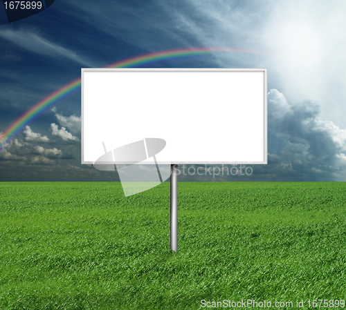 Image of billboard and green grass and blue cloudly sky