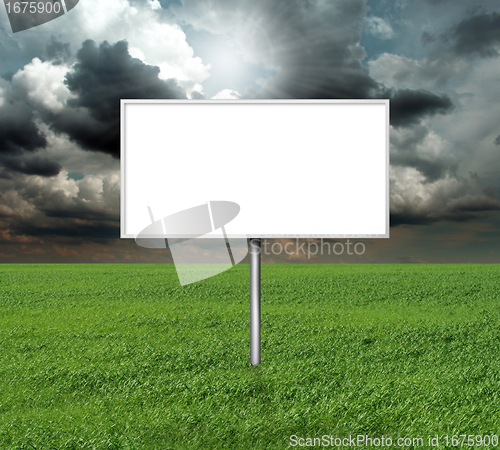 Image of billboard and green grass and blue cloudly sky