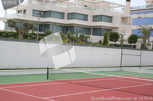 Image of Tennis court in front of this apartment-buildings