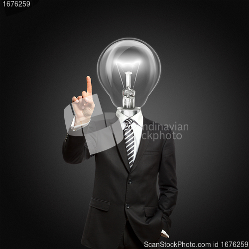 Image of businessman with lamp-head push the button