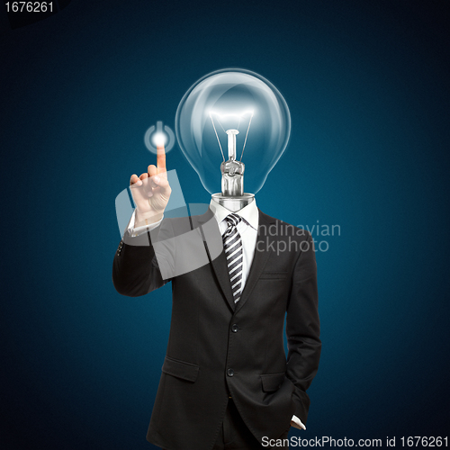 Image of businessman with lamp-head push the button