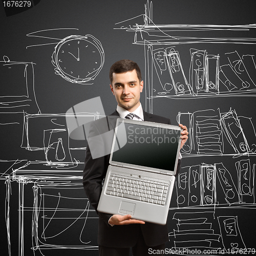 Image of businessman with open laptop in his hands