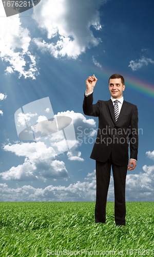 Image of businessman writting something with marker outdoors