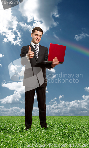 Image of Full length portrait of male with laptop outdoors