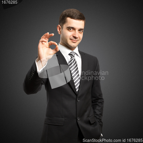 Image of happy businessman in suit shows OK