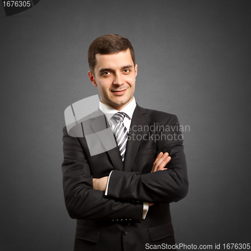Image of male in suit with crossed hands