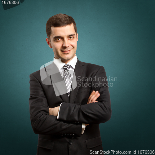 Image of male in suit with crossed hands