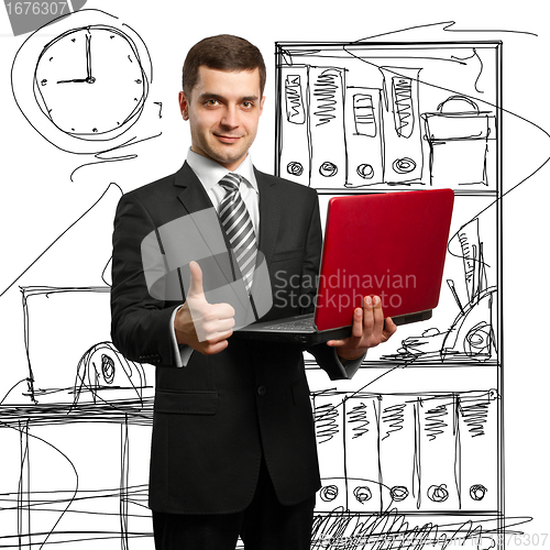 Image of male in suit with laptop in his hands