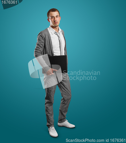 Image of male in with laptop in his hands